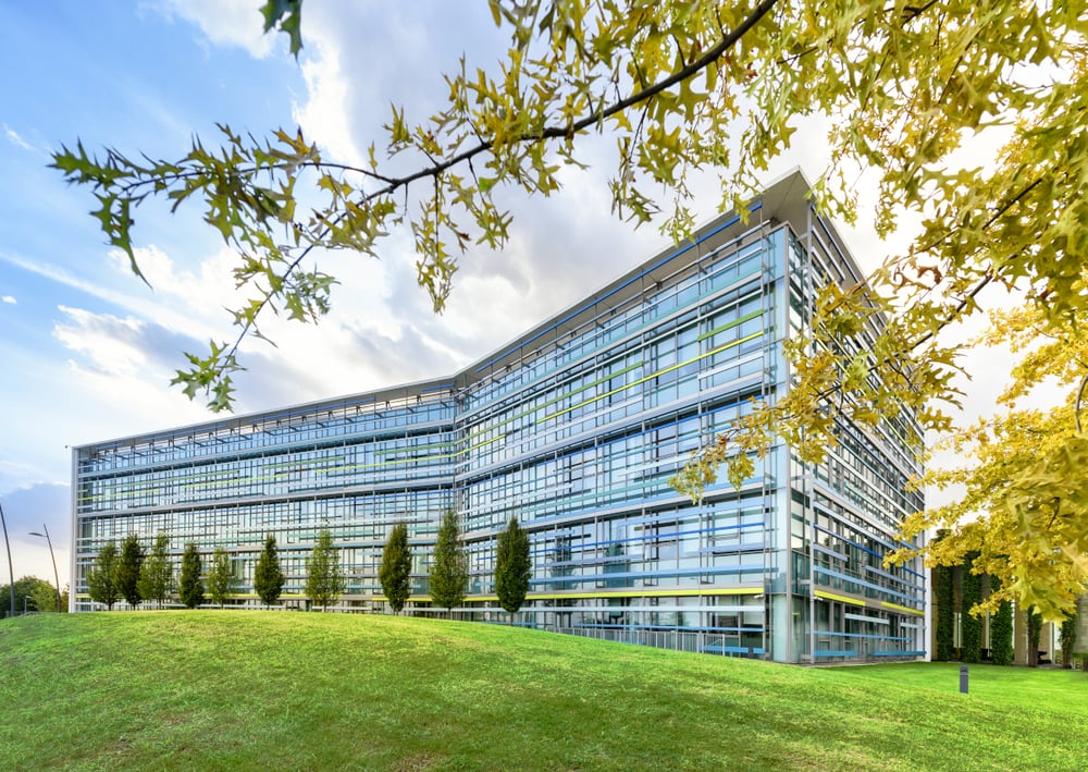 glass office building with green turf